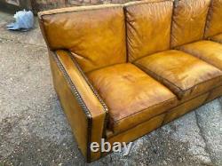 A Huge Four seater vintage Tan leather sofa with studs Made in England