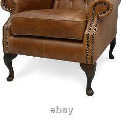 Chesterfield High Back Wing Chair & Footstool Presented In Vintage Tan Leather